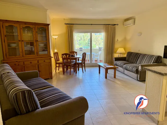 Family apartment — Spacious living and dining room with multiple seating areas