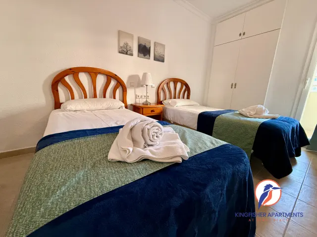 One-bedroom apartment — Separate bedroom with a double bed and single bed