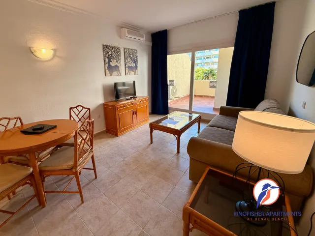 One-bedroom apartment — Living and dining room opening onto the terrace
