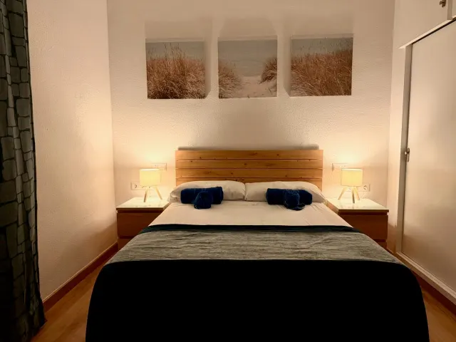 Premium one-bedroom apartment — Separate double bedroom with bedside lighting