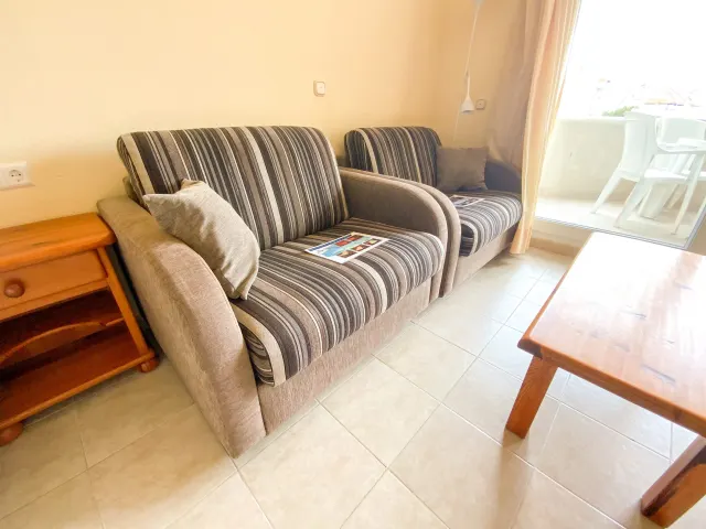 Studio apartment — Lounge seating beside the private terrace