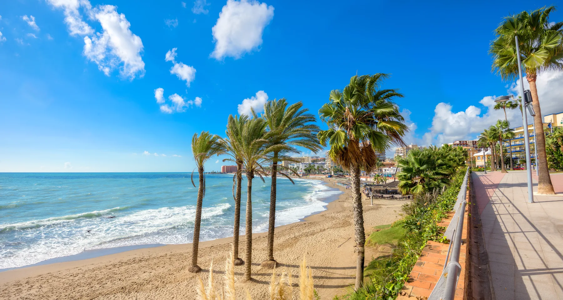 Palm-lined beach and the blue Mediterranean in Benalmádena