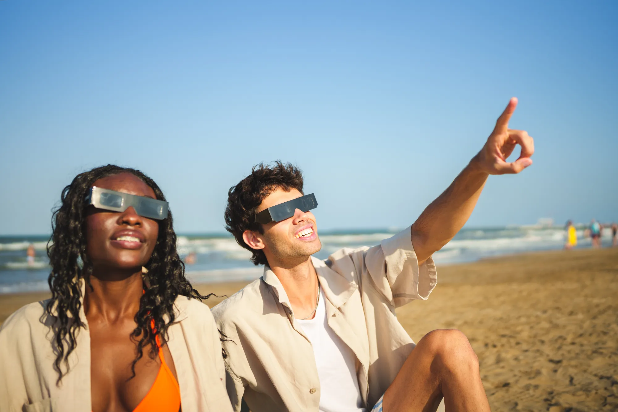 Guests enjoying a solar eclipse safely from a beach