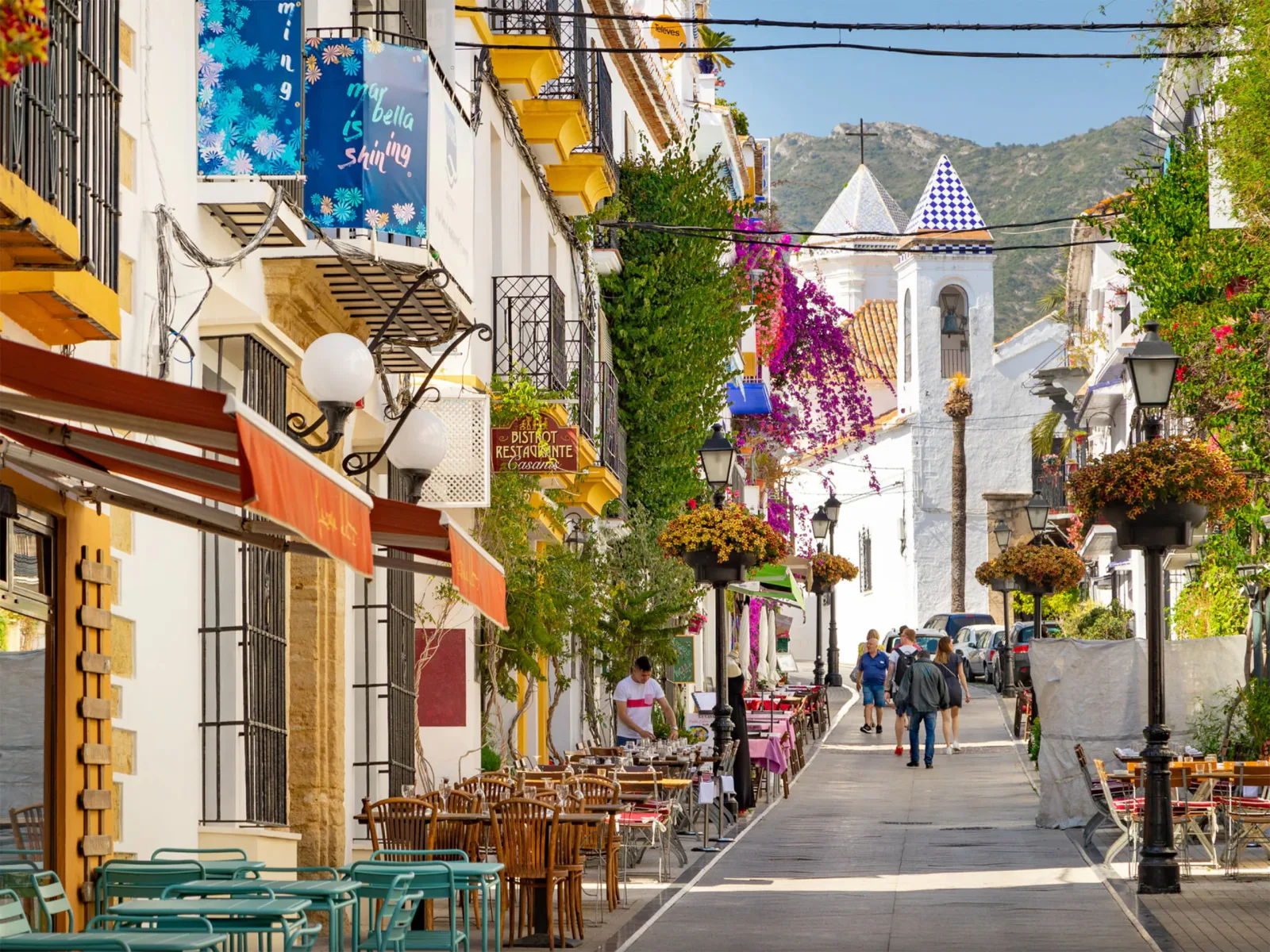 Bloemrijke straat met cafés en witgekalkte gebouwen in de oude binnenstad van Marbella
